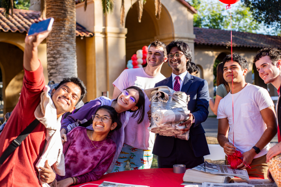 [STANFORD, CA] — November 7, 2023: A team of Stanford College Republicans and Stanford Dems celebrate their completed newspaper-table on Democracy Day 2023.  (Photo by Anthony Chen/Ethography for Stanford University Communications)